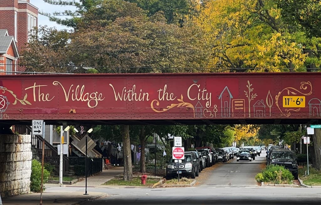 Roscoe Village railroad bridge mural reading The Village Within the City